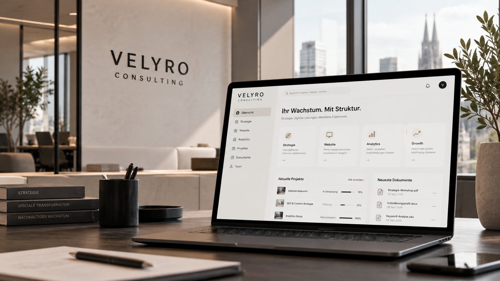 Laptop mit Velyro Oberfläche in einem modernen Büro, im Hintergrund das Velyro Consulting Logo an der Wand
